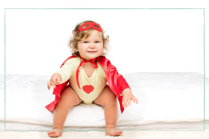 baby girl in a cape to represent baby names inspired by feminists for 2024