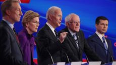 Tom Steyer (L), Sen. Elizabeth Warren (D-MA), Sen. Bernie Sanders (I-VT) and former South Bend, Indiana Mayor Pete Buttigieg (R) listen as former Vice President Joe Biden (C) speaks during the Democratic presidential primary debate at Drake University on Jan. 14, 2020 in Des Moines, Iowa.