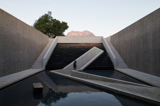 Sculptural ramps and staircases with water element at the The Chuan malt whisky distillery by Neri and Hu