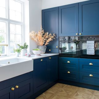 kitchen room with white window blue kitchen cabinet