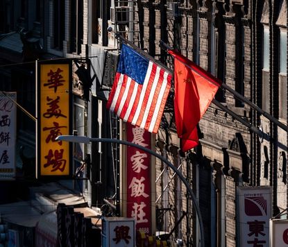 topshot a us and chinese flag are seen in chinatown on october 14, 2019 in new york city photo by johannes eisele afp photo by johannes eiseleafp via getty images