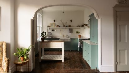 Portable kitchen island ideas - a vintage inspired kitchen with pale green cabinets and a moveable island in the middle of the room