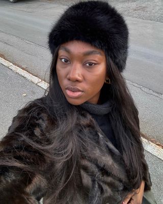 Scandi fashion influencer @nnennaechem wearing a chic winter outfit with rich-looking accessories.