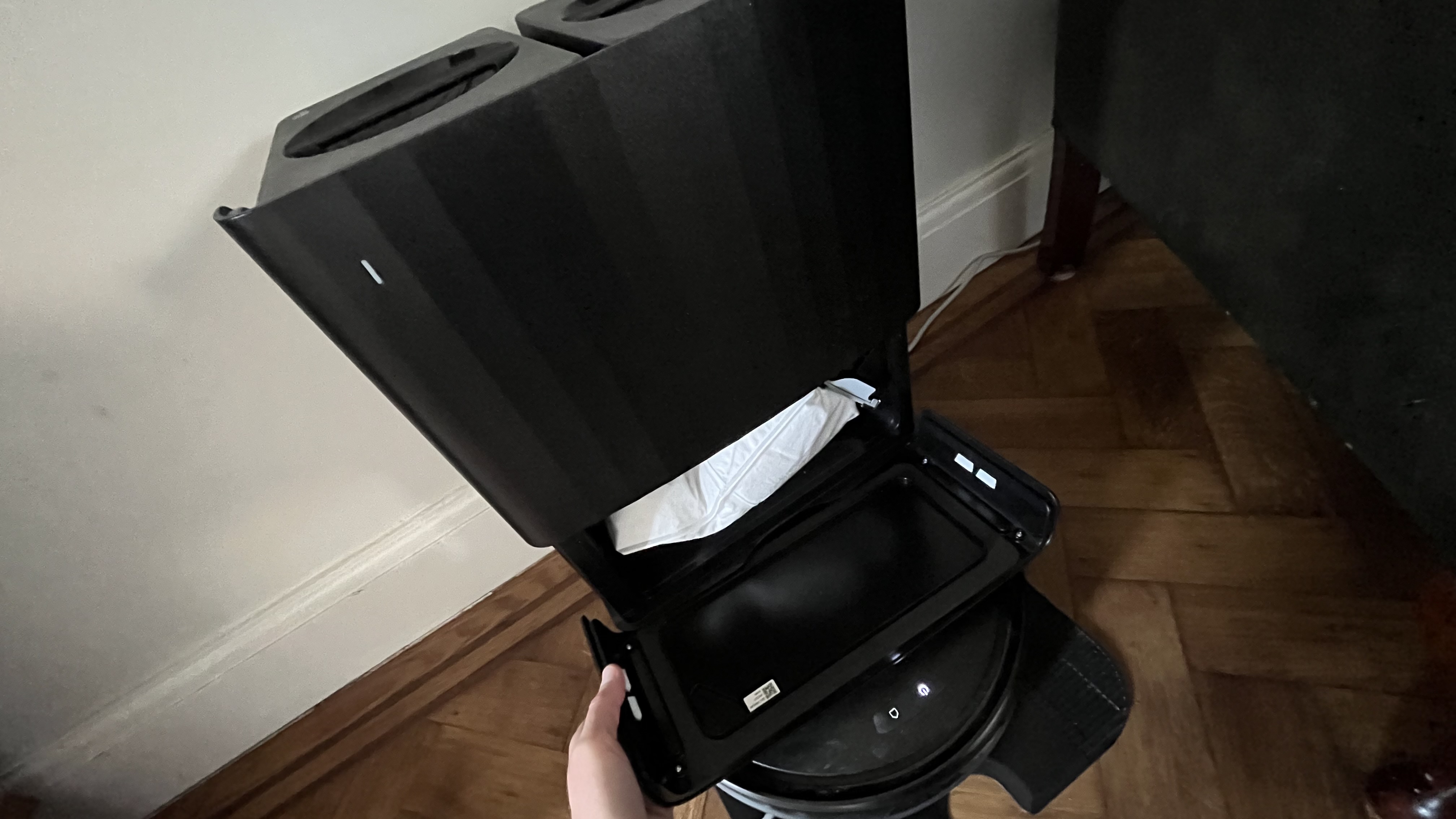 opening up the cover to the roborock Qrevo S Pro dock reveals dustbag location