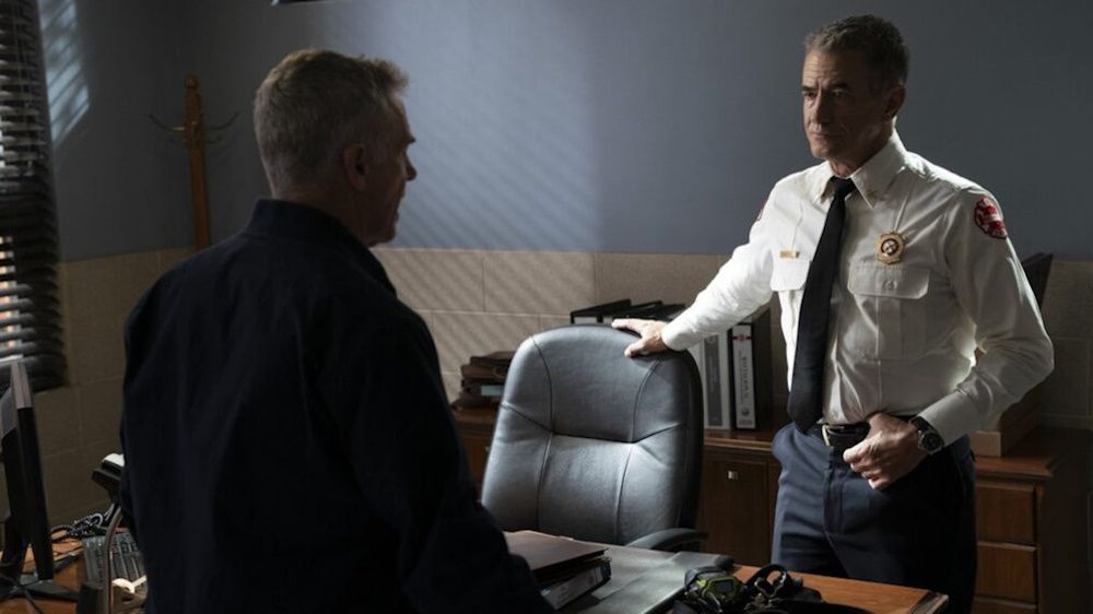 Dermot Mulroney as Chief Dom Pascal talking to David Eigenberg as Christopher Herrmann in an episode from season 13 of Chicago Fire