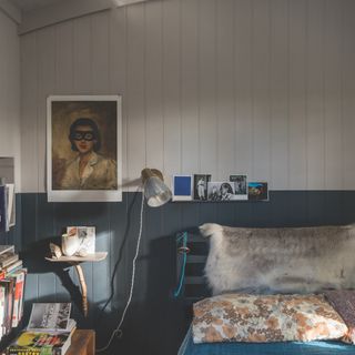 design rules for small bedrooms, charcoal and stone painted tongued groove, teal bedding, sheepskin, 70s style cushion, postcards, artwork, wall light