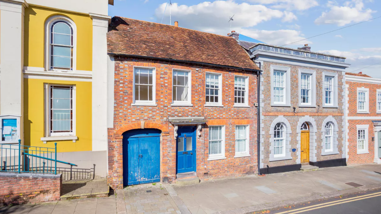 A high-street town-house with blue garage door