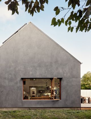 Side view of grey concrete house with window
