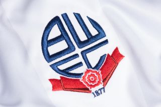 The Bolton Wanderers badge on a white shirt