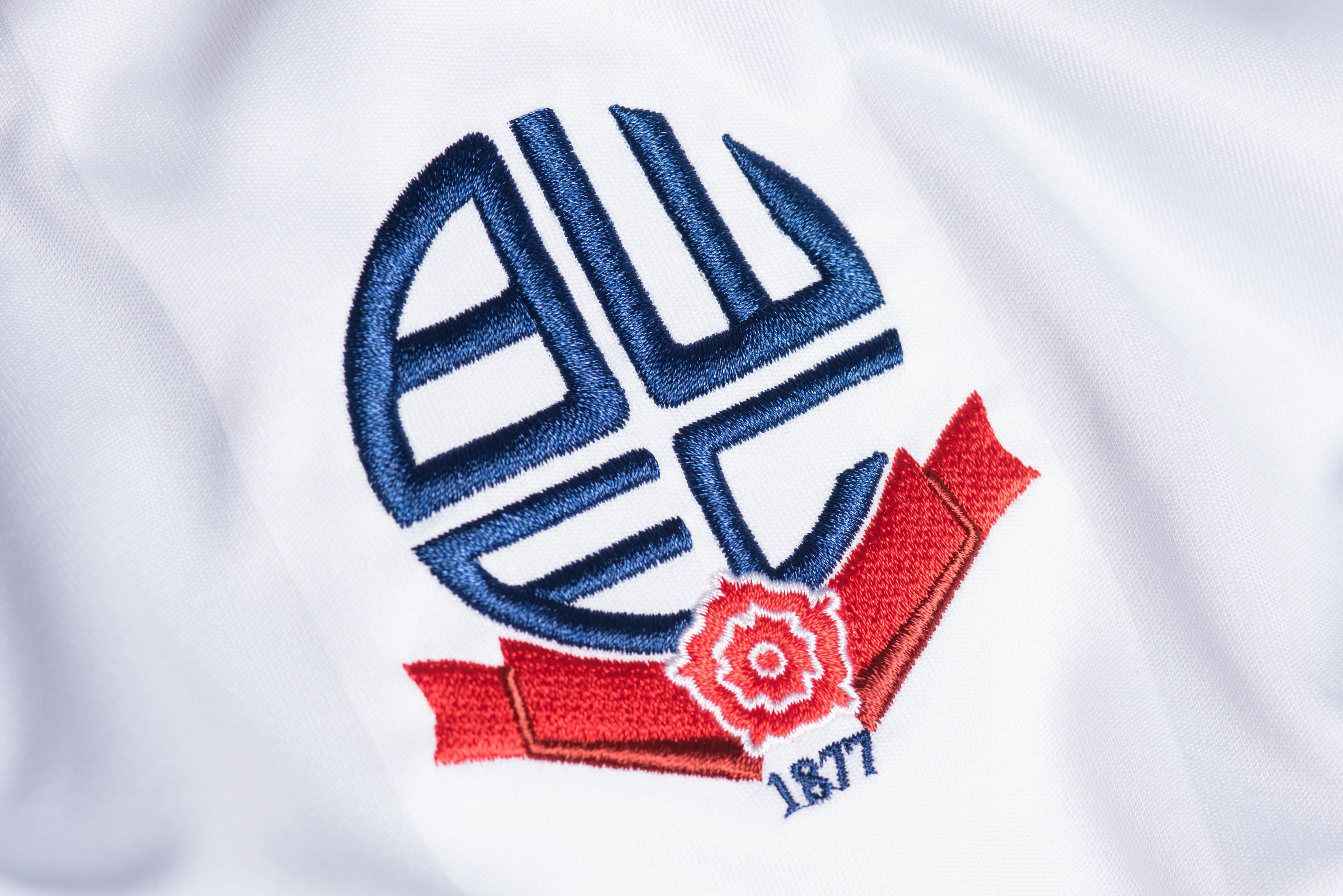 The Bolton Wanderers badge on a white shirt