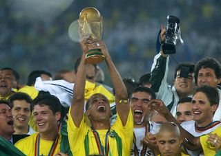 Rivaldo holds the trophy aloft as Brazil players celebrate their World Cup final win over Germany in June 2002.