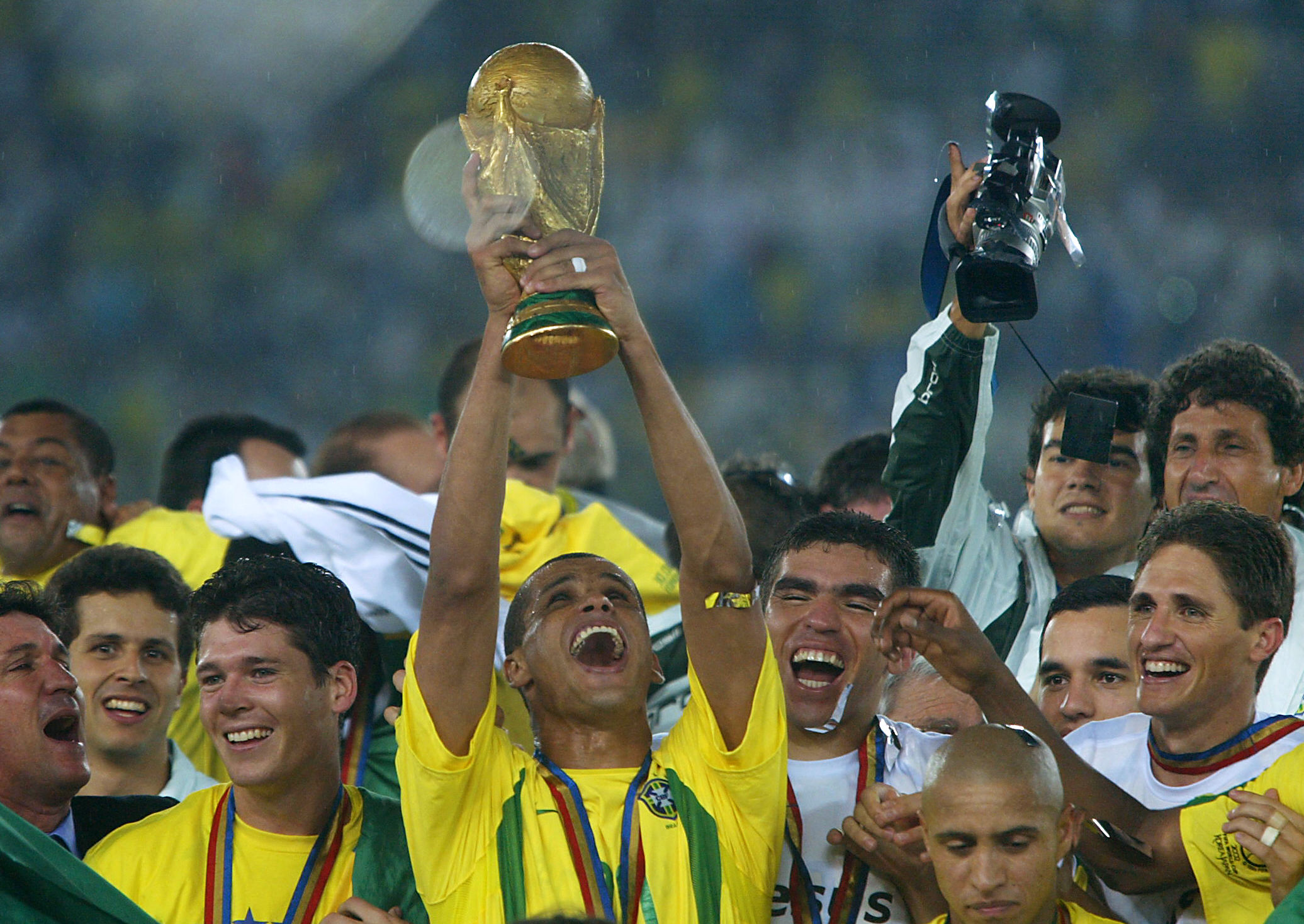 Rivaldo holds the trophy aloft as Brazil players celebrate their World Cup final win over Germany in June 2002.