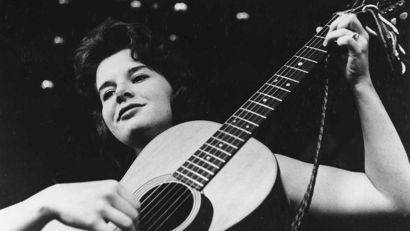 Bonnie Dobson playing an acoustic guitar