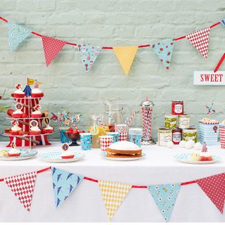room with colourful bunting flags and sweets