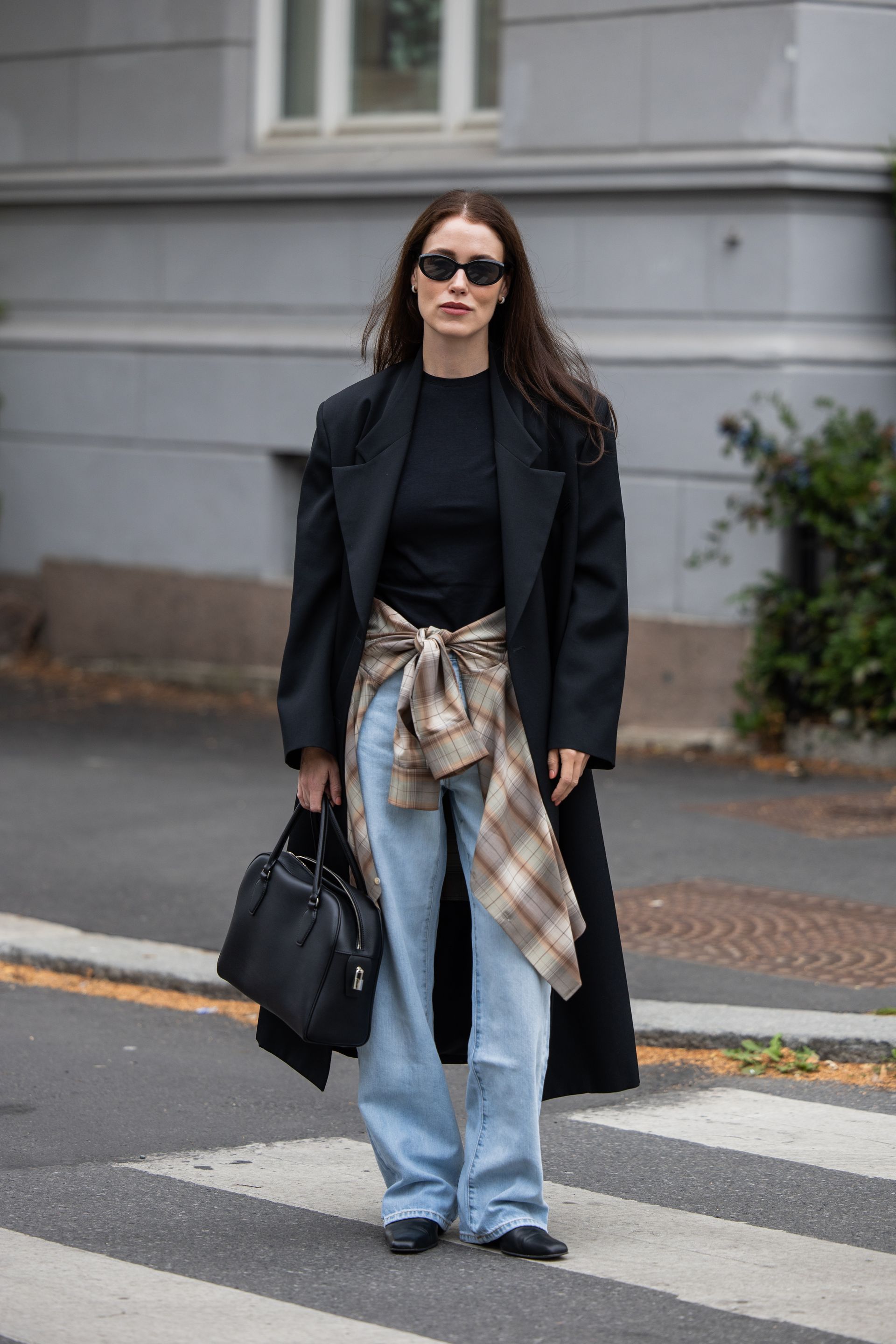 An image of Annabel Rosendahl wearing wide-leg jeans with a blazer and a flannel shirt.