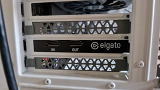 Elgato Game Capture 4K Pro's connection ports sticking out the back of a gaming PC