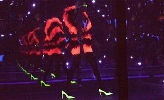Ultraviolet light, and their final looks – like stilettos, feathered mini dresses, striped blazers and fur coats were illuminated in neon hues accordingly.