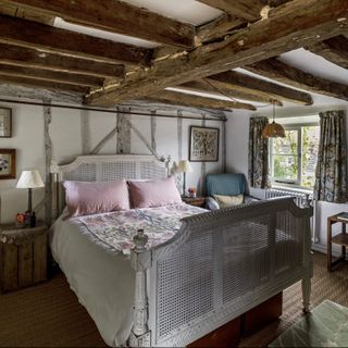 bedroom with wooden beams and bed