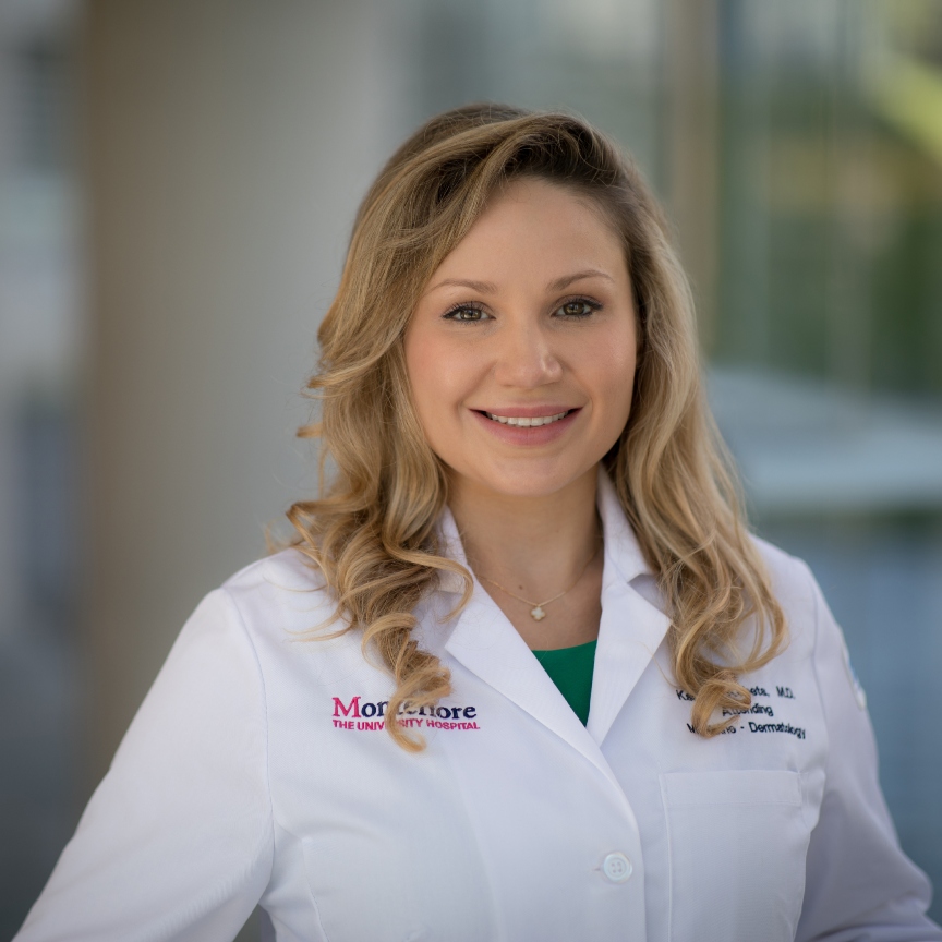 a white woman with blonde hair in a white lab coat