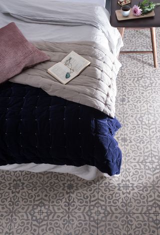 Mezzo patterned tiles in a bedroom with blue bedding