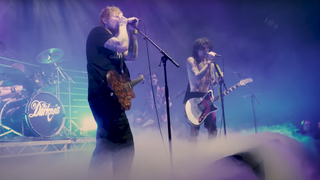 Ed Sheeran plays a Lowden GL-10 on stage with The Darkness