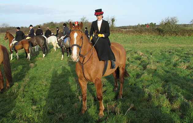 Tinsel-clad Maria Mc Namara riding sidesaddle with the North Galway Foxhounds on Boxing Day