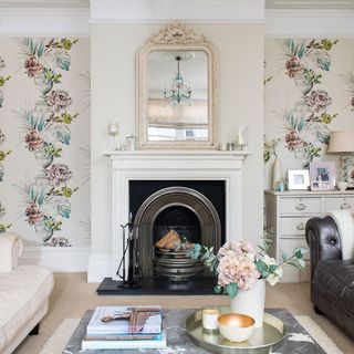 living room with fire place and printed wallpaper