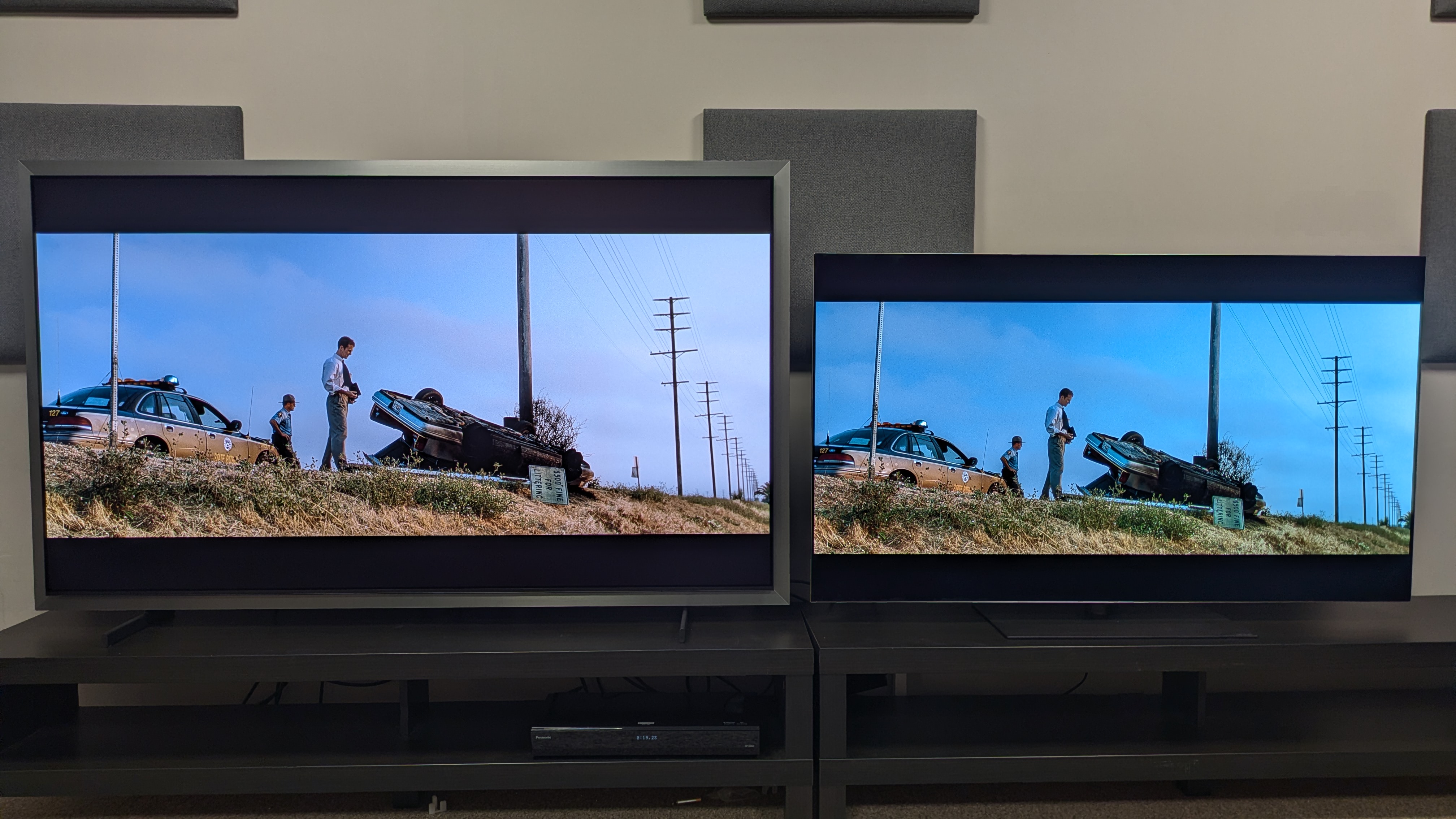 Samsung S99H (left) vs LG G6 (right) showingthe narrator next to an overturned car from Fight Club. The S99H shows higher fullscreen brightness, with a bolder looking blue sky