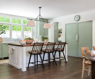 kitchen with green cabinets and white island