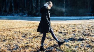 woman walking in a snowy field