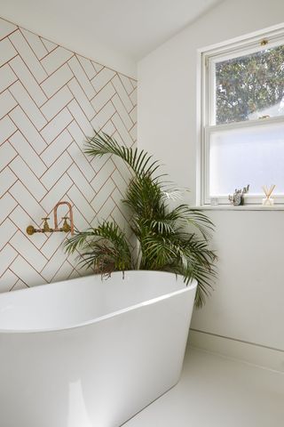white bathroom with red subway tile grouting