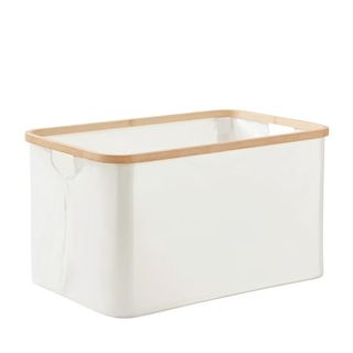 a white Collapsible Canvas Laundry Basket with a bamboo trim at the top. 