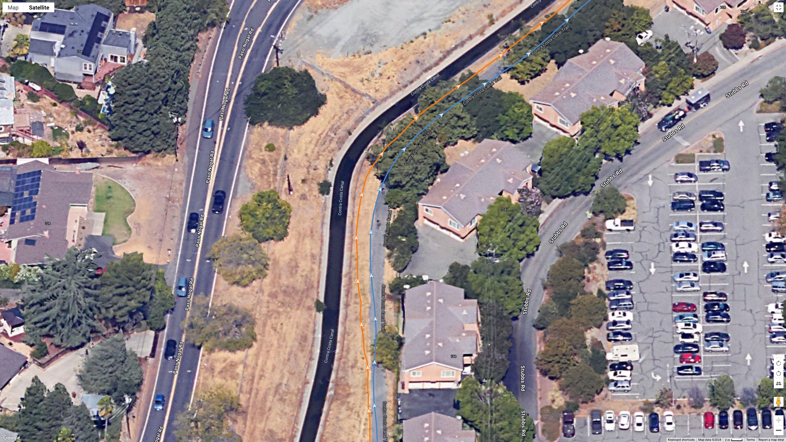 A Google Earth satellite image showing GPS lines for the COROS PACE Pro (blue) and Garmin Fenix 8 (orange) to test their dual-band GPS accuracy.