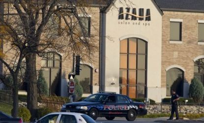 Police personnel work outside the Azana Salon and Spa in Brookfield, Wis., where three people were killed and four others wounded after a mass shooting on Sunday. 