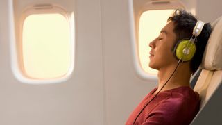 man wearing headphones on plane