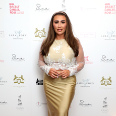 Lauren Goodger at red carpet event wearing gold dress with lace detailing.