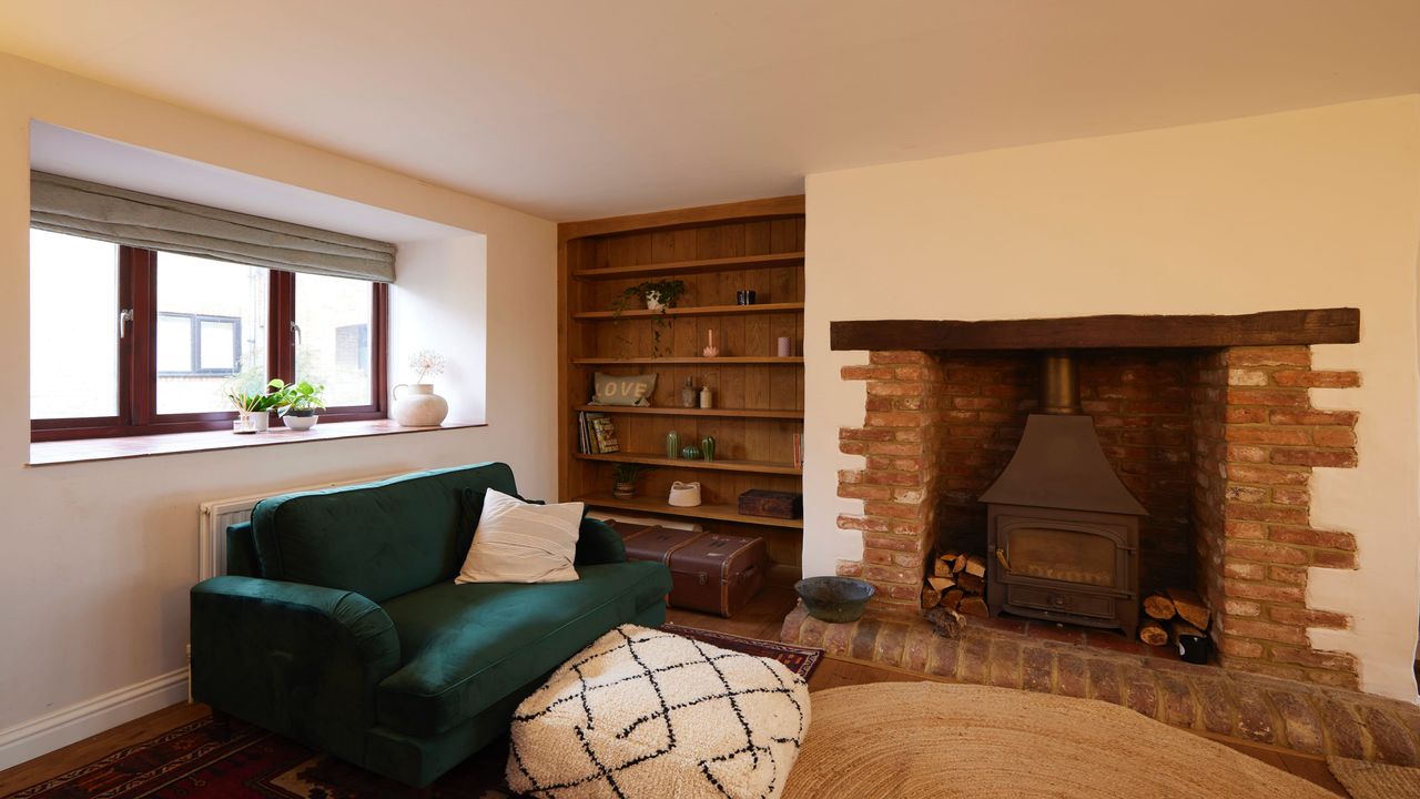 living room with green armchair and fireplace