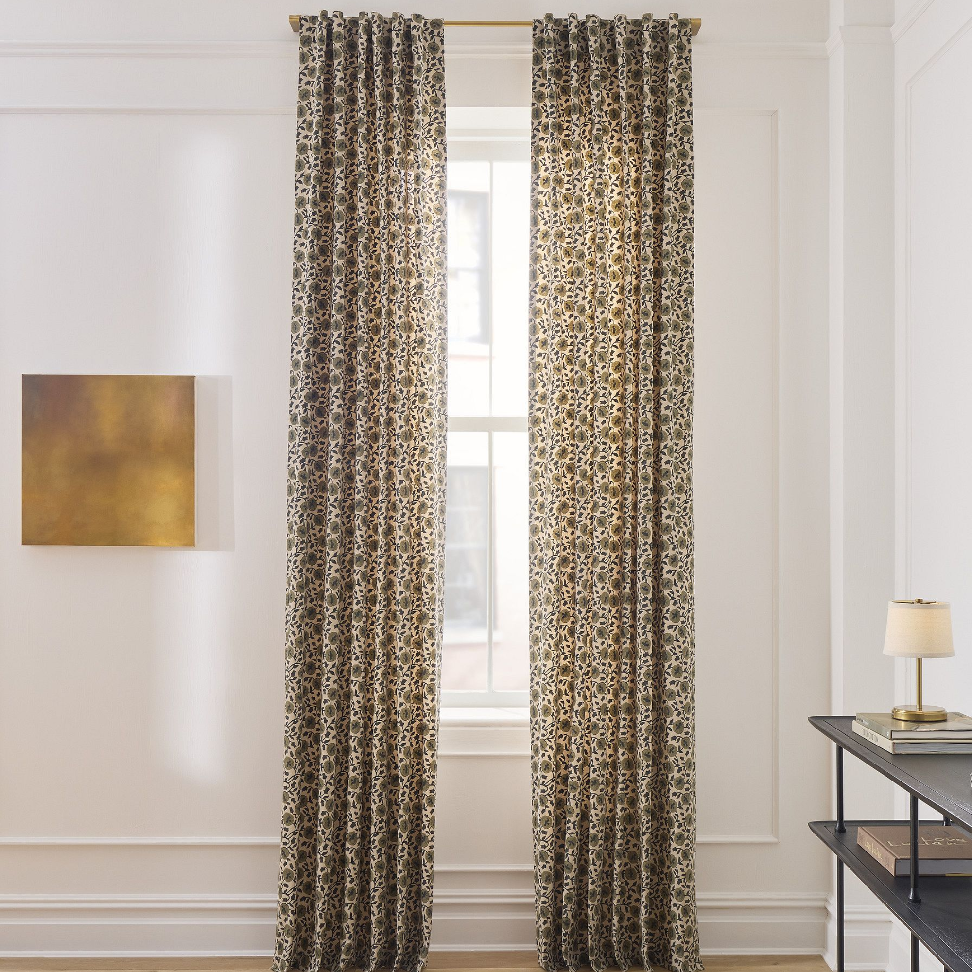 a pair of floral curtains hanging in front of a window