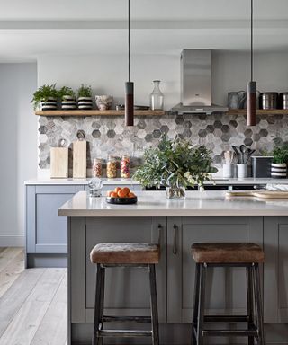 Gray hexagonal tiles in a kitchen with an island and bar stools