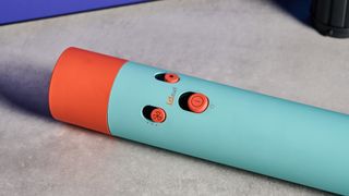 the dyson airwrap ID in teal and terracotta colorway (patina and orange) with a lapis case, with a brush, hairfryer, curling wand attachments