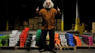 Best Electro-Harmonix pedals: A photo of Mike Matthews, founder of Electro-Harmonix in front of a pile of pedal boxes