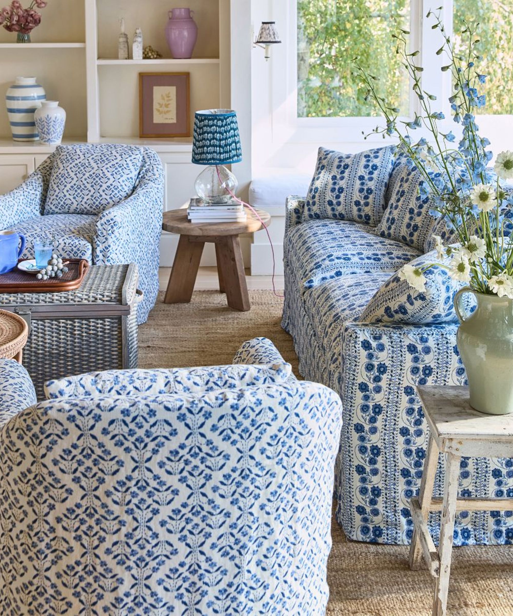 country style blue and white living room with floral slipcovered couch and matching arm chairs