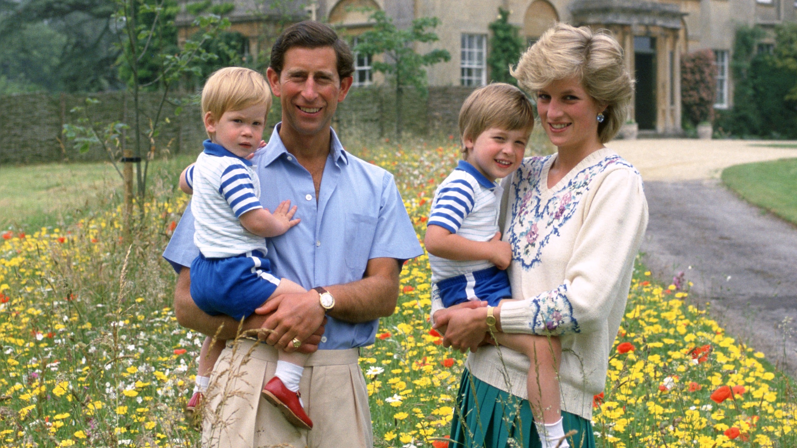 King Charles and Diana, Princess of Wales pose with their sons Prince William and Prince Harry in the wild flower meadow at Highgrove on July 14, 1986