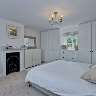 white bedroom with wardrobe and carpet floor