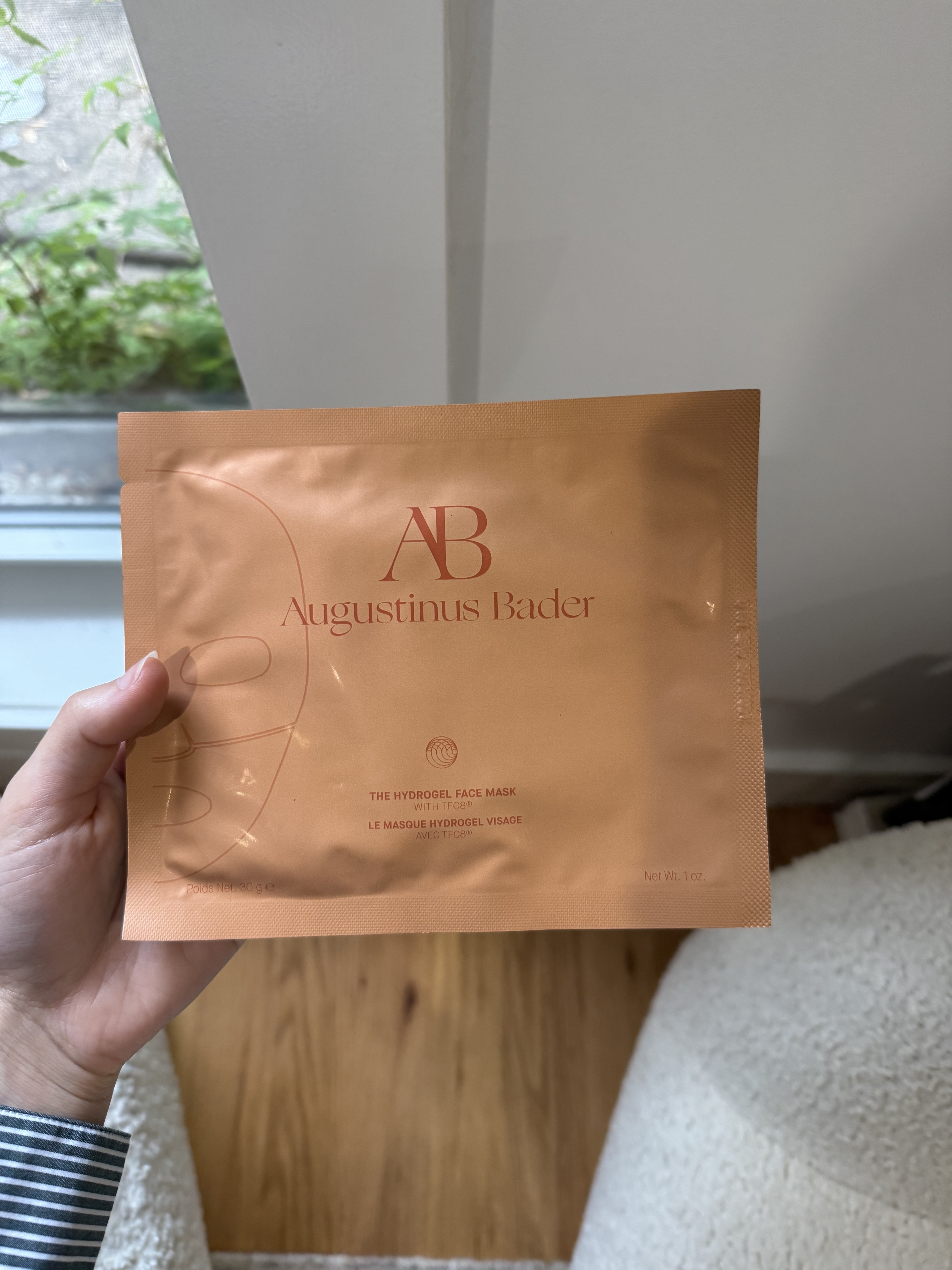 Photo of Jamie Schneider testing the Augustinus Bader sheet mask
