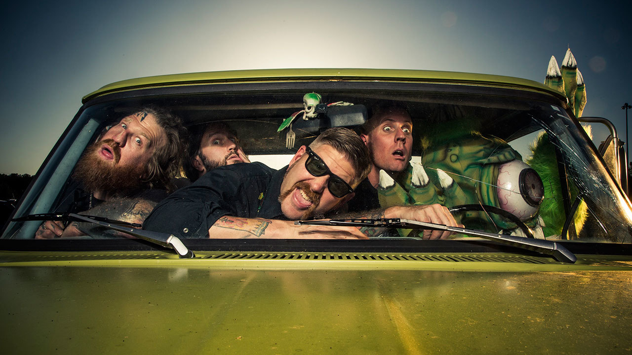 A press shot of the members of Mastodon all crowded into a car