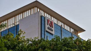 An image of a building with the Adobe sign on the side, shot from below