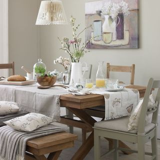 dining table with cushions and flower vase