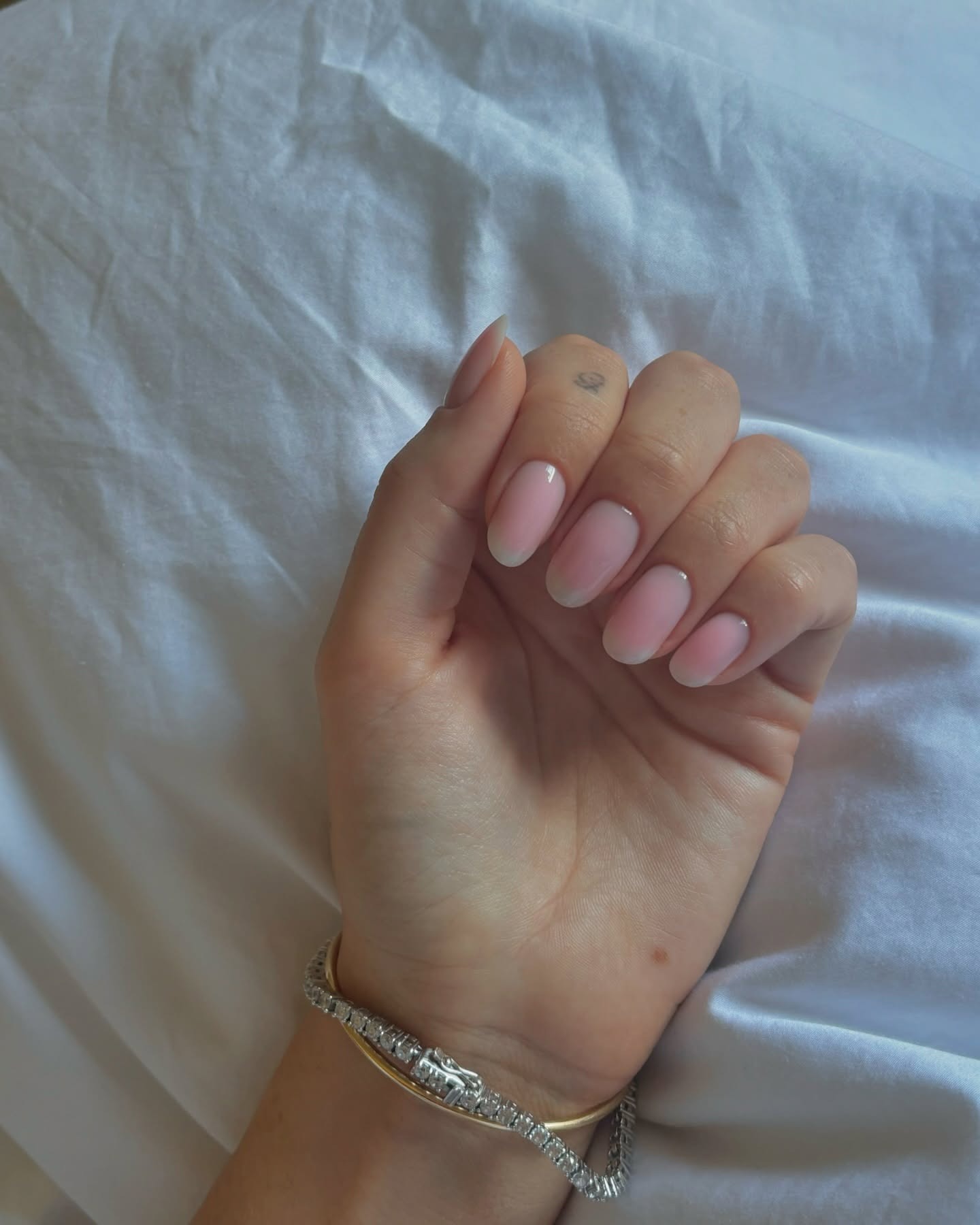 A close-up picture of a cloudy French manicure