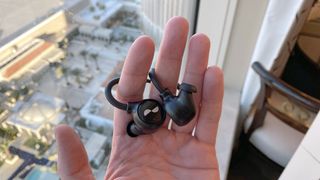 Nuraloop earbuds in a hand